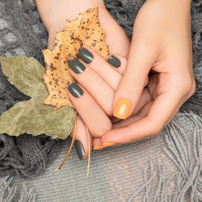 Female,Hands,With,Green,And,Yellow,Autumn,Nail,Design.,Female