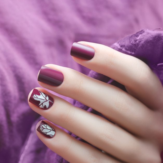 Female,Hand,With,Dark,Purple,Nail,Design