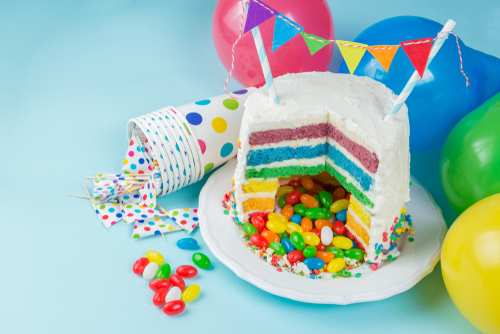 Rainbow,Pinata,Cake,With,Candies,-,Birthday,Background,,Card,,Concept
