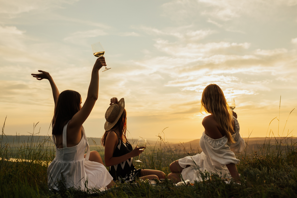 Group,Of,Girl,Friends,With,Wine,Glasses,Chilling,On,Picnic