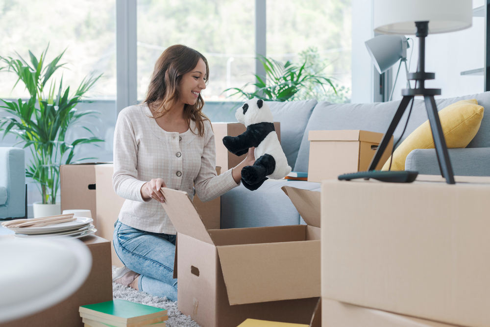 Happy,Woman,Unpacking,In,Her,New,House,,She,Is,Taking