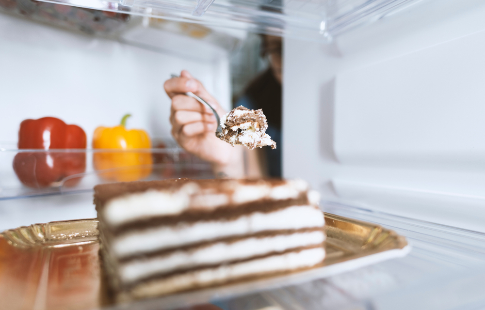 Hungry,Woman,Eating,A,Dessert,Straight,From,The,Fridge,Using
