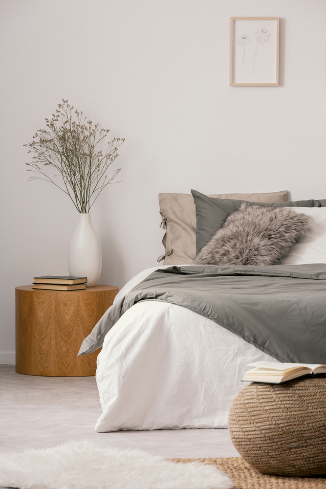 Wooden,Nightstand,Table,Next,To,King,Size,Bed,With,White