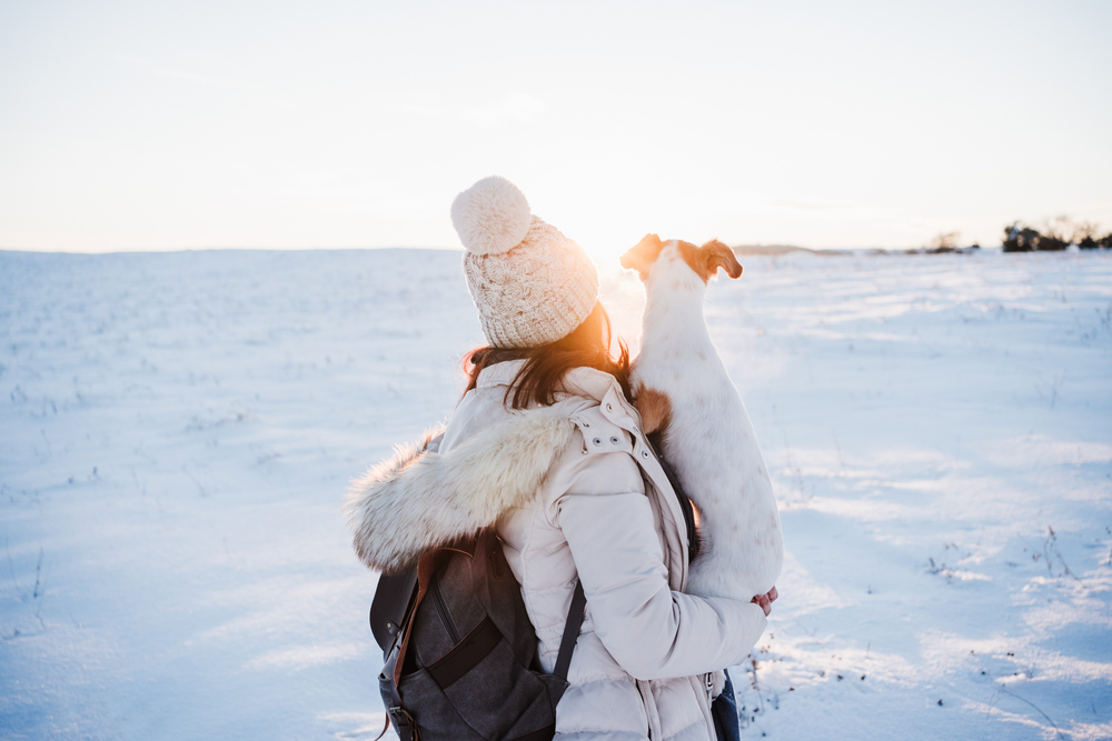 Back,View,Of,Woman,In,Snowy,Mountain,Wearing,Modern,Coat