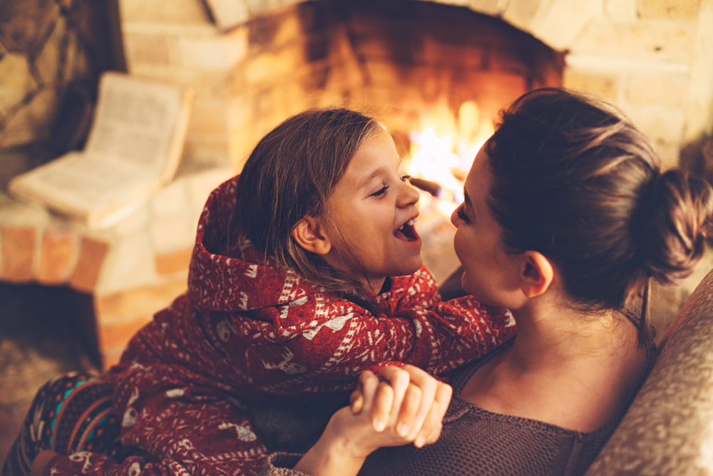 Mom,With,Child,Playing,And,Chilling,By,The,Fire,Place