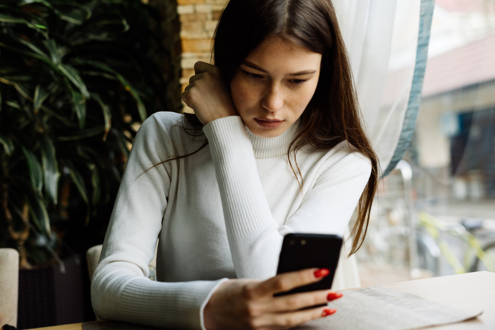 Beautiful,Young,Dark-haired,Girl,In,A,White,Sweater,Sits,In