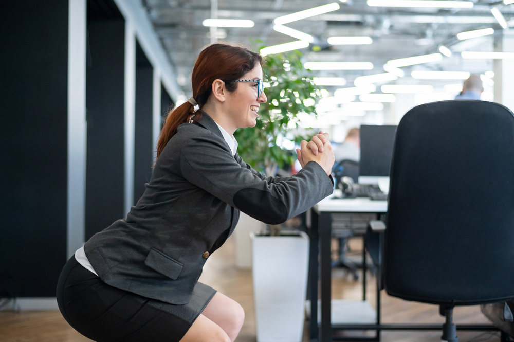 Happy,Business,Woman,Squat,In,Open,Space,Office.,A,Red-haired