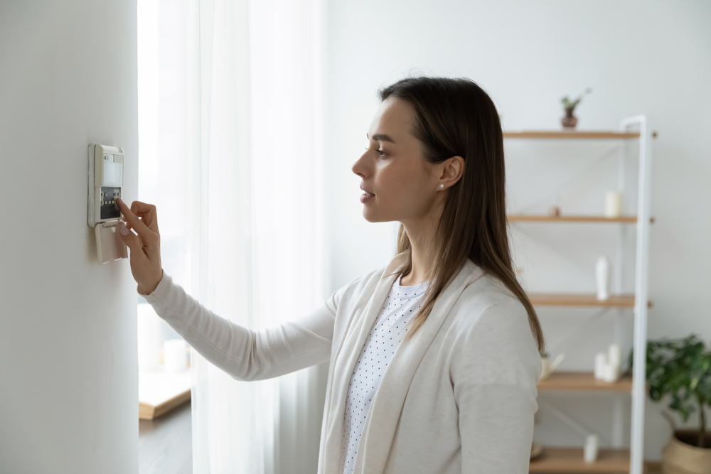 Side,View,Pleasant,Young,Woman,Using,Smart,Home,System,Or