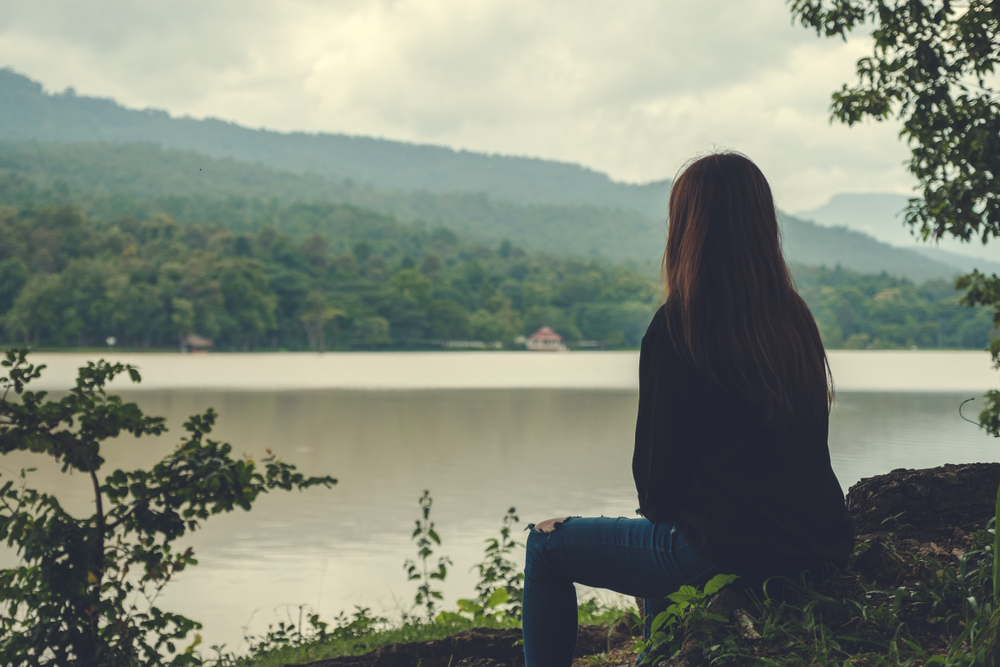 Closeup,Image,Of,An,Asian,Woman,Sitting,Alone,By,The