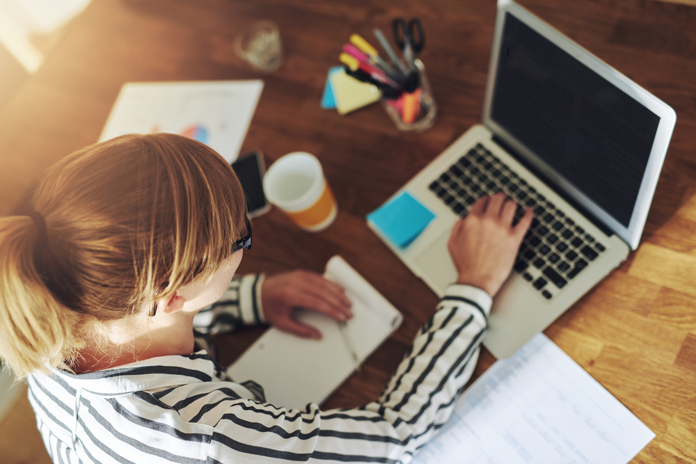 Young,Female,Entrepreneur,Working,Sitting,At,A,Desk,Typing,On