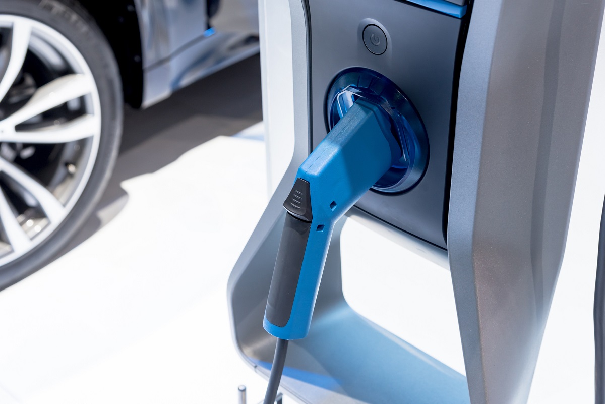 Charging an electric car with chargepoint. Electric vehicle (EV). eco-friendly Lifestyle.
