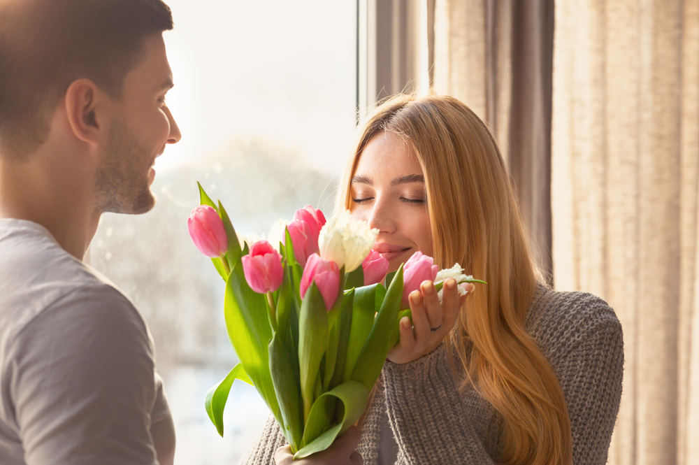 Affectionate,Young,Man,Giving,Bouquet,Of,Flowers,To,His,Wife