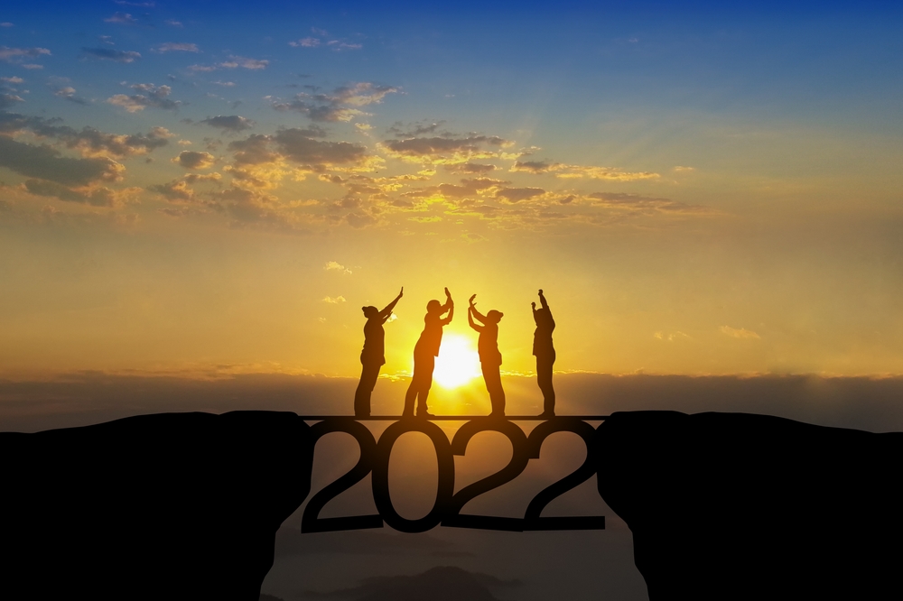Silhouette,Of,Happy,Teamwork,Standing,At,The,Top,Of,2022