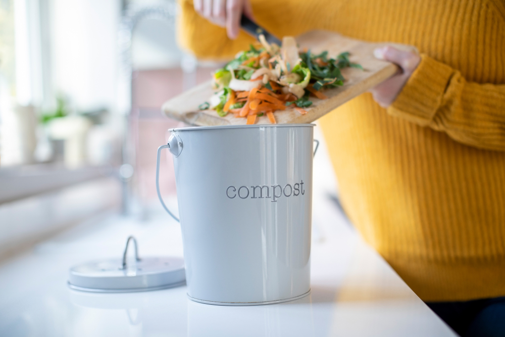 Close,Up,Of,Woman,Making,Compost,From,Vegetable,Leftovers,In