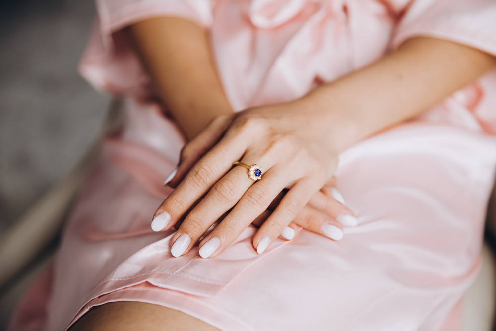 Young,Girl,In,A,Pink,Silk,Dressing,Gown,Sits,Clasped
