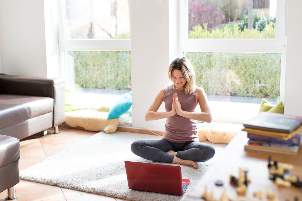 Young,Woman,Is,Doing,Yoga,Online.,A,Woman,Is,Sitting