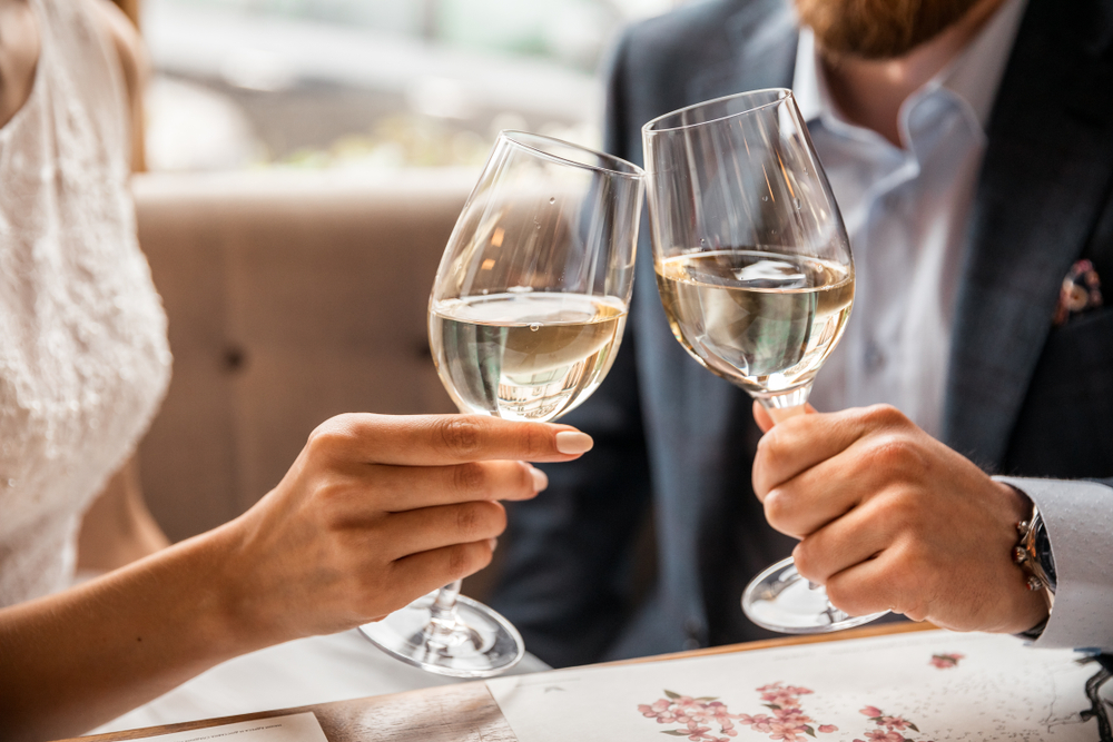 Young,Couple,With,Glasses,Of,White,Wine,On,A,Date