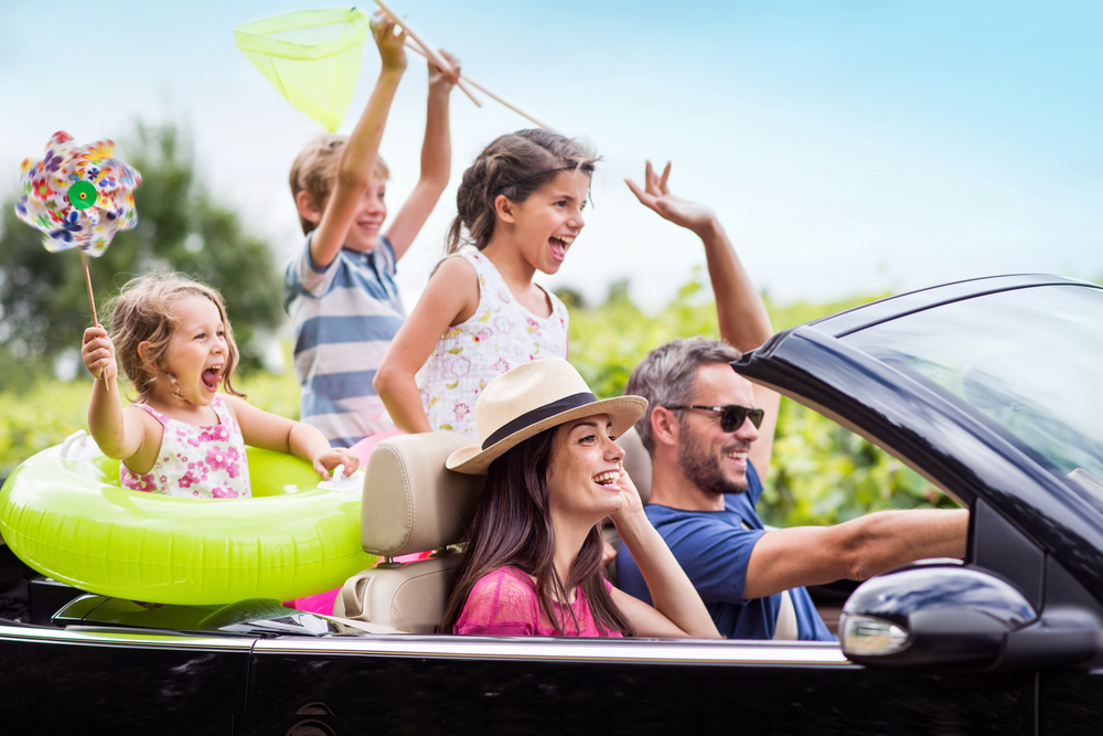 A,Joyful,Family,,In,A,Convertible,Car,,Goes,On,Holiday