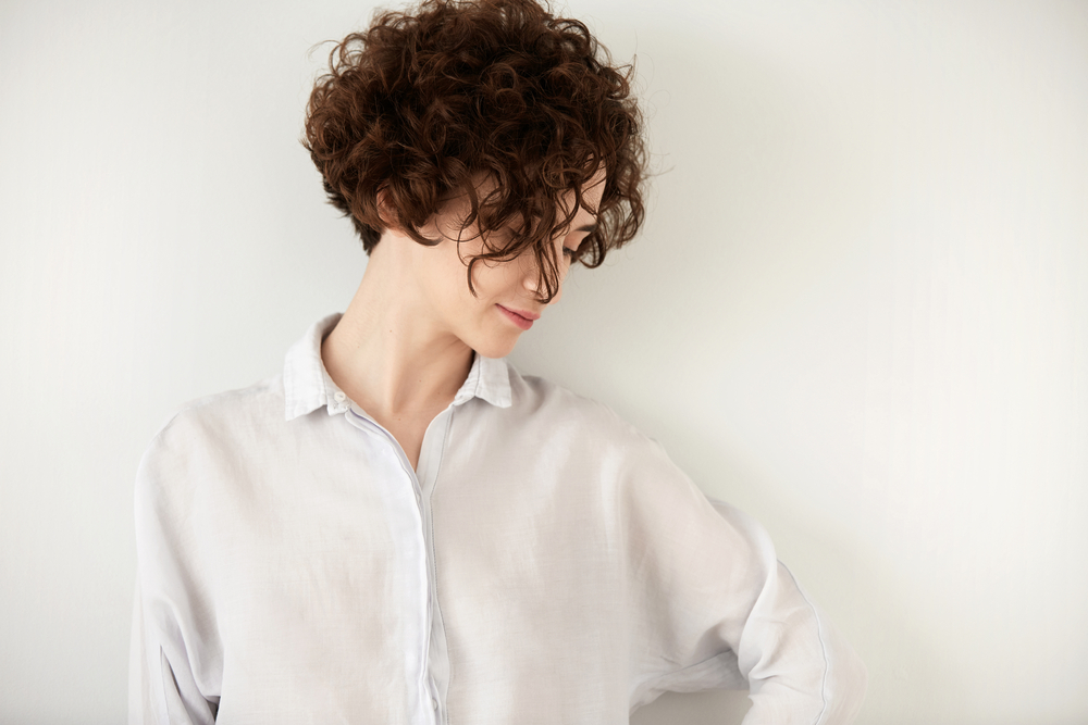 Romantic,Girl,In,Stylish,White,Shirt,With,Short,Curly,Brunette