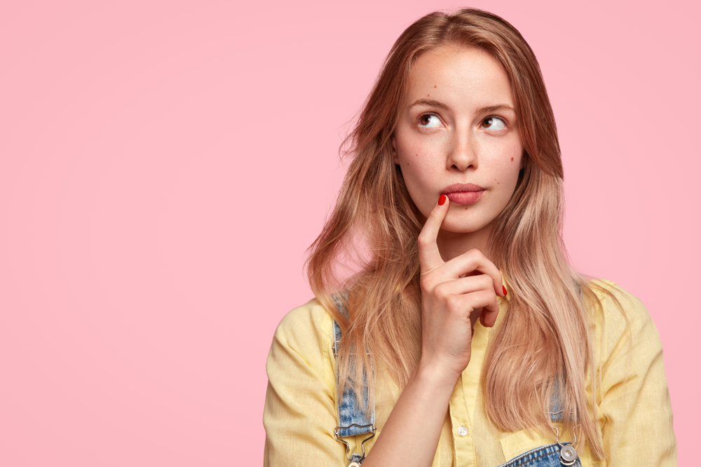 Thoughtful,Female,Youngster,Keeps,Fore,Finger,Near,Lips,,Being,Deep