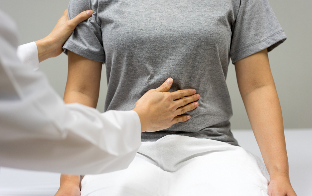 Female,Doctor,Are,Examining,By,Abdominal,Palpation,Of,Female,Patient