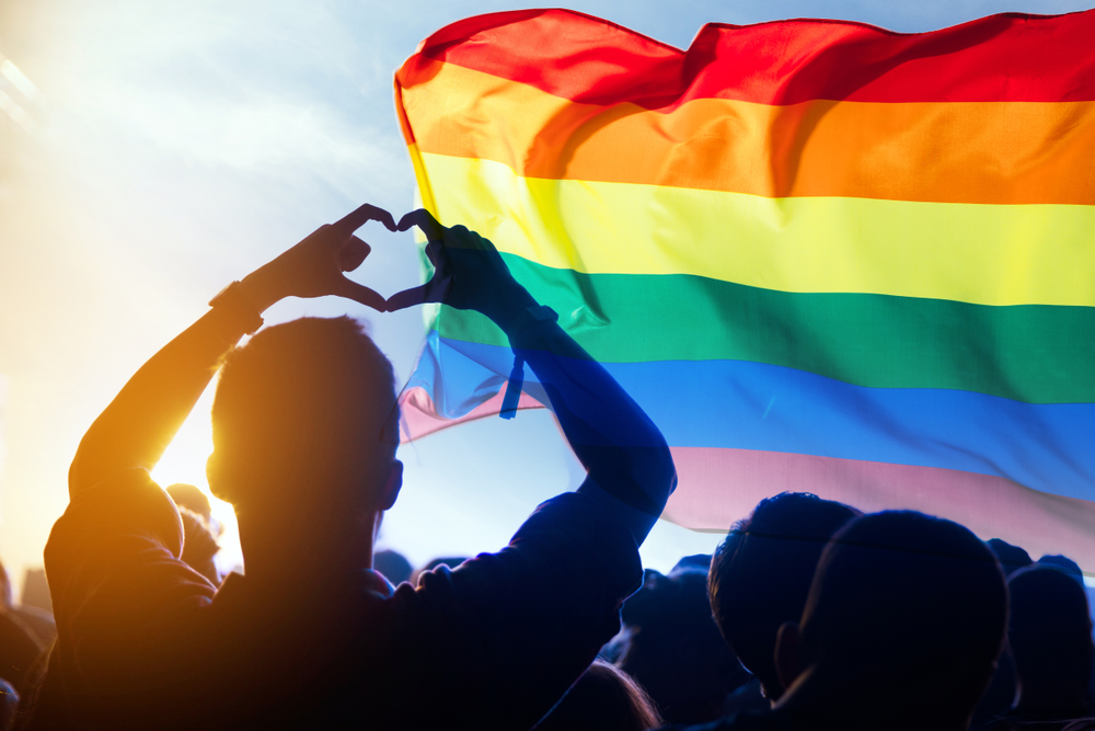 Pride,Community,At,A,Parade,With,Hands,Raised,And,The