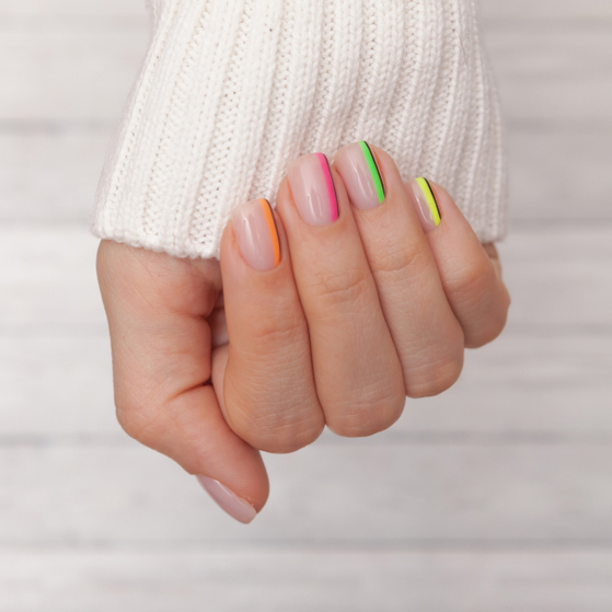 Beautiful,Groomed,Woman's,Hands,With,Colored,Nails,On,The,Wooden