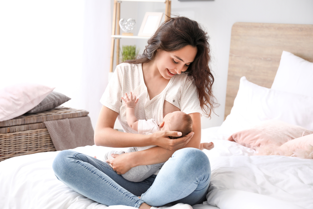 Young,Woman,Breastfeeding,Her,Baby,At,Home