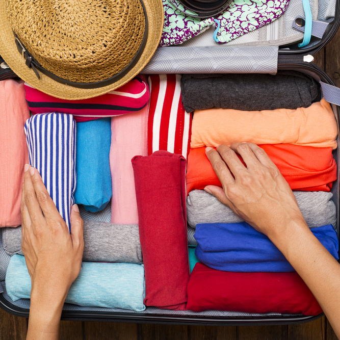 Woman,Packing,A,Luggage,For,A,New,Journey
