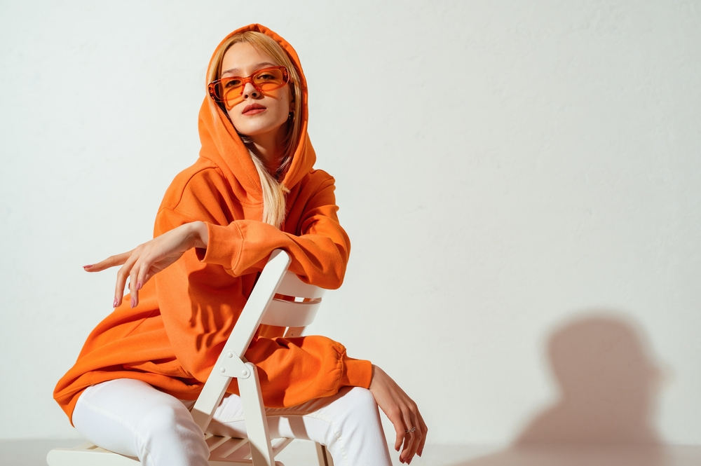 Fashionable,Confident,Blonde,Woman,Wearing,Trendy,Orange,Sweatshirt,,Color,Sunglasses,