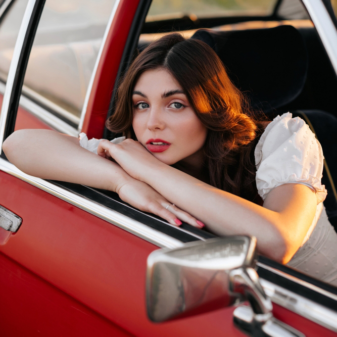 A,Young,Woman,With,Long,Curly,Hair,And,Red,Lips