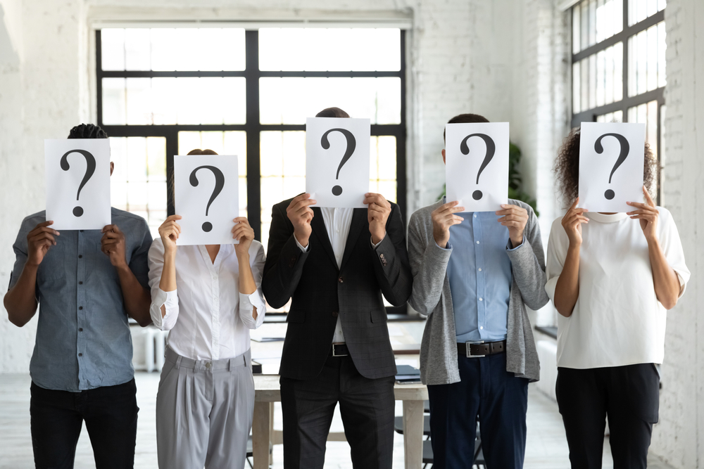 Diverse,Business,People,Hiding,Faces,Behind,Papers,Sheets,With,Question