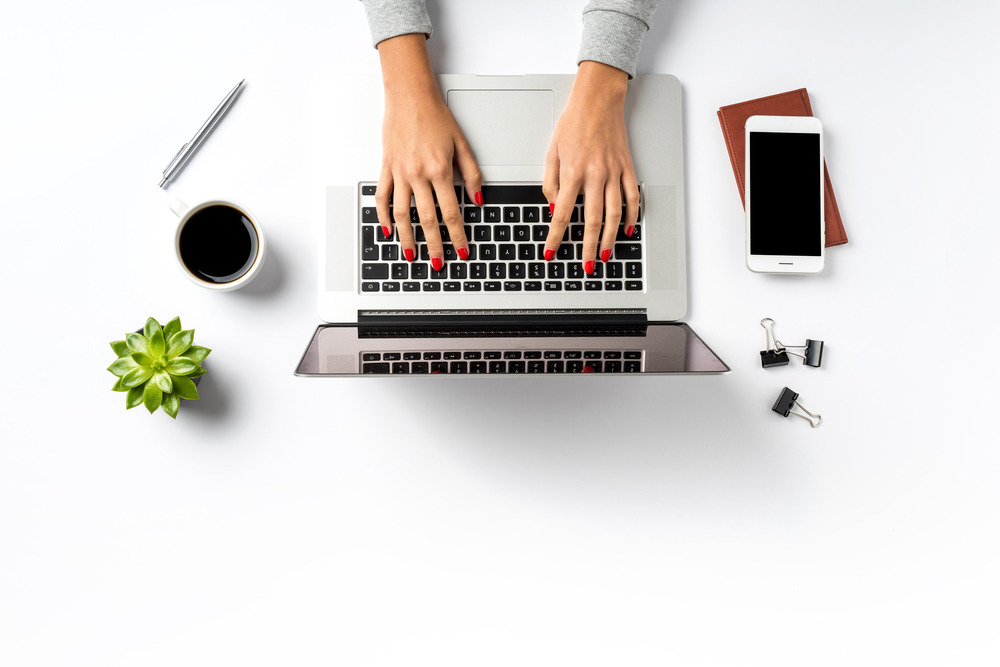 Female,Hands,Working,On,Modern,Laptop.,Office,Desktop,On,White