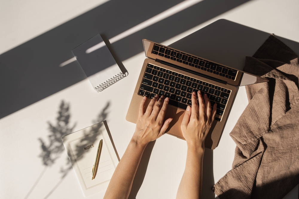 Flatlay,Of,Person,Hands,Working,On,Laptop,Computer.,Aesthetic,Bohemian
