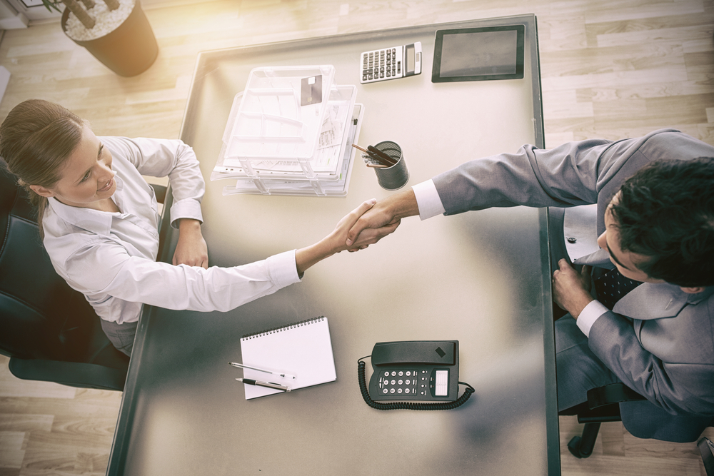 Above,View,Of,Young,Consultant,Shaking,Hands,With,Customer