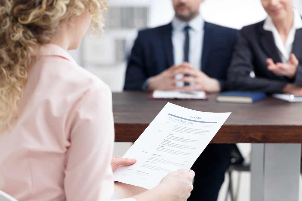 Young,Woman,Holding,Her,Resume,During,Job,Interview