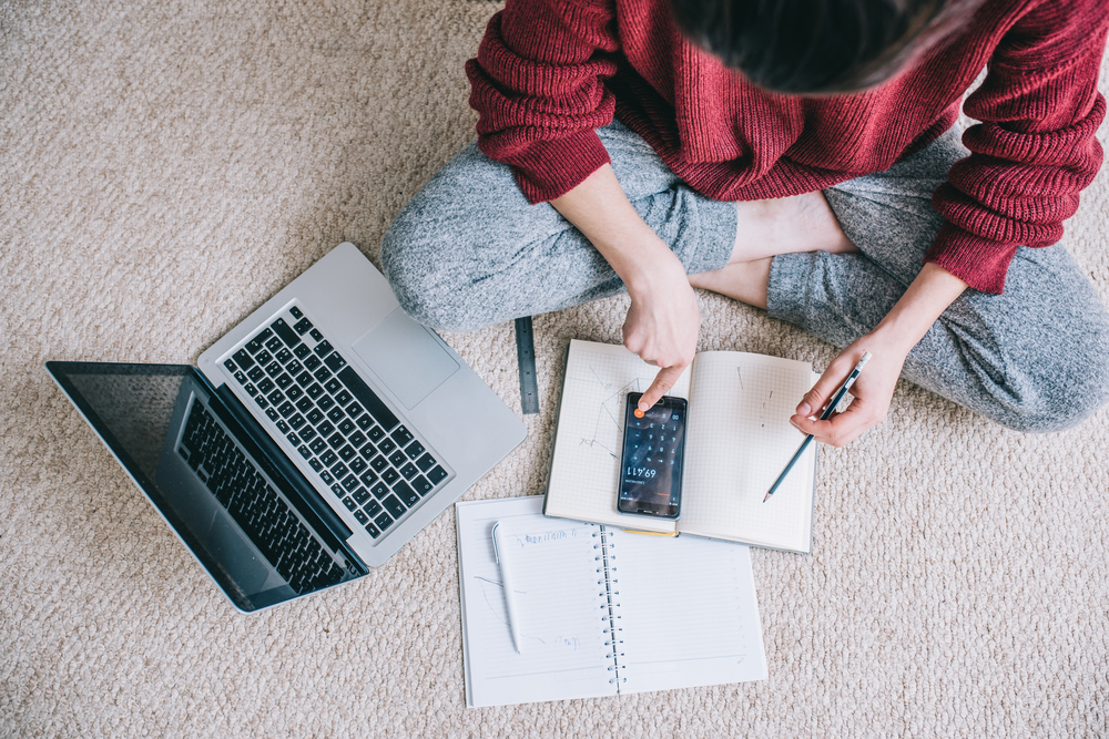 Overhead,View,Of,Young,Brunette,Woman,Using,Laptop,Managing,Domestic