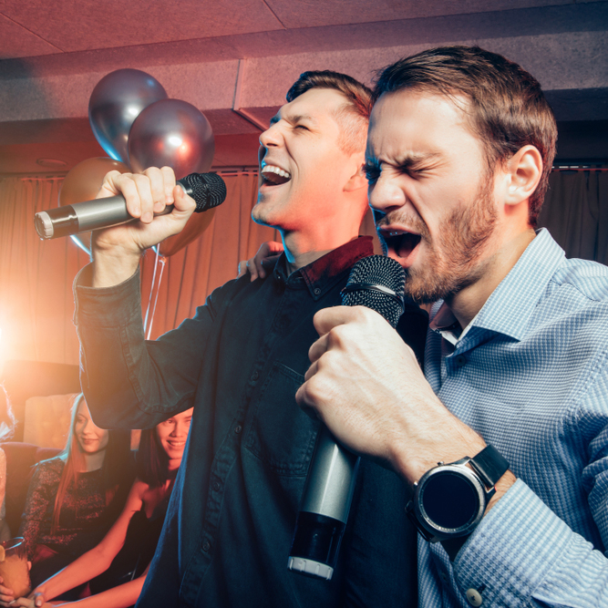 Two,Young,Caucasian,Men,In,T-shirts,Singing,In,Microphone,In