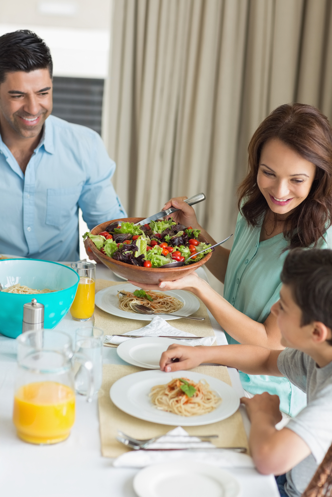 Portrait,Of,Happy,Family,Of,Three,Sitting,At,Dining,Table