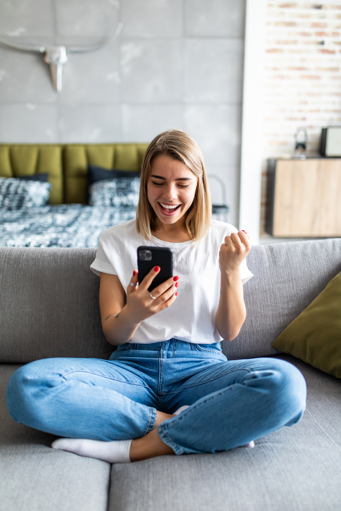 Excited,Woman,Watching,Media,Content,On,Line,In,A,Mobile