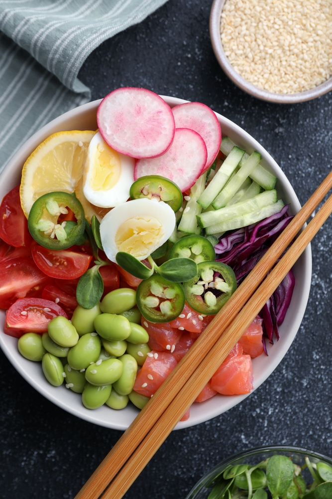 Poke,Bowl,With,Salmon,,Edamame,Beans,And,Vegetables,On,Black
