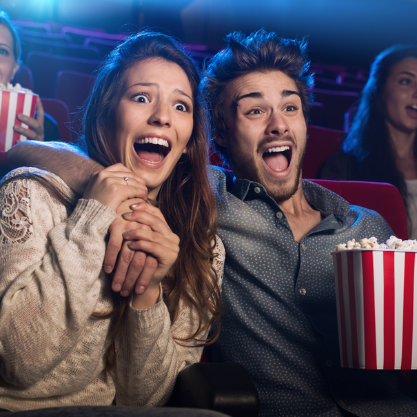 Young,Scared,Couple,At,The,Cinema,Watching,An,Horror,Movie