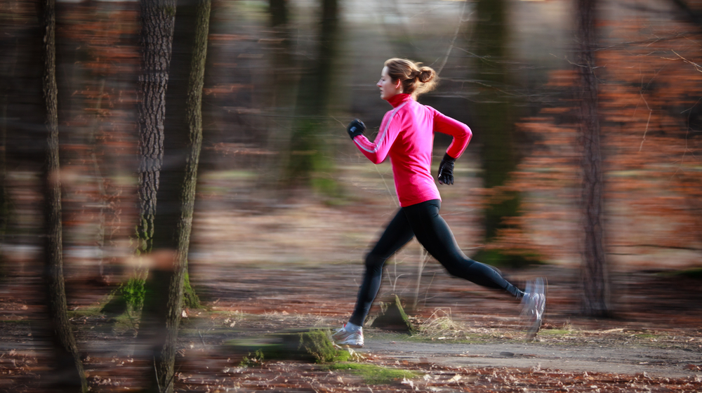Young,Woman,Running,Outdoors,In,A,City,Park,On,A