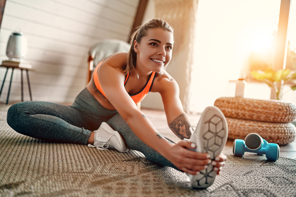 Athletic,Woman,In,Sportswear,Doing,Fitness,Stretching,Exercises,At,Home