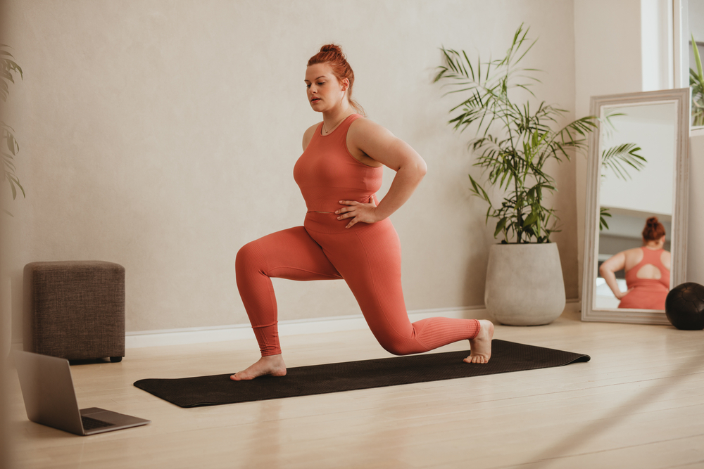 Plus,Size,Female,In,Sportswear,Doing,Lunge,Workout,Watching,Online
