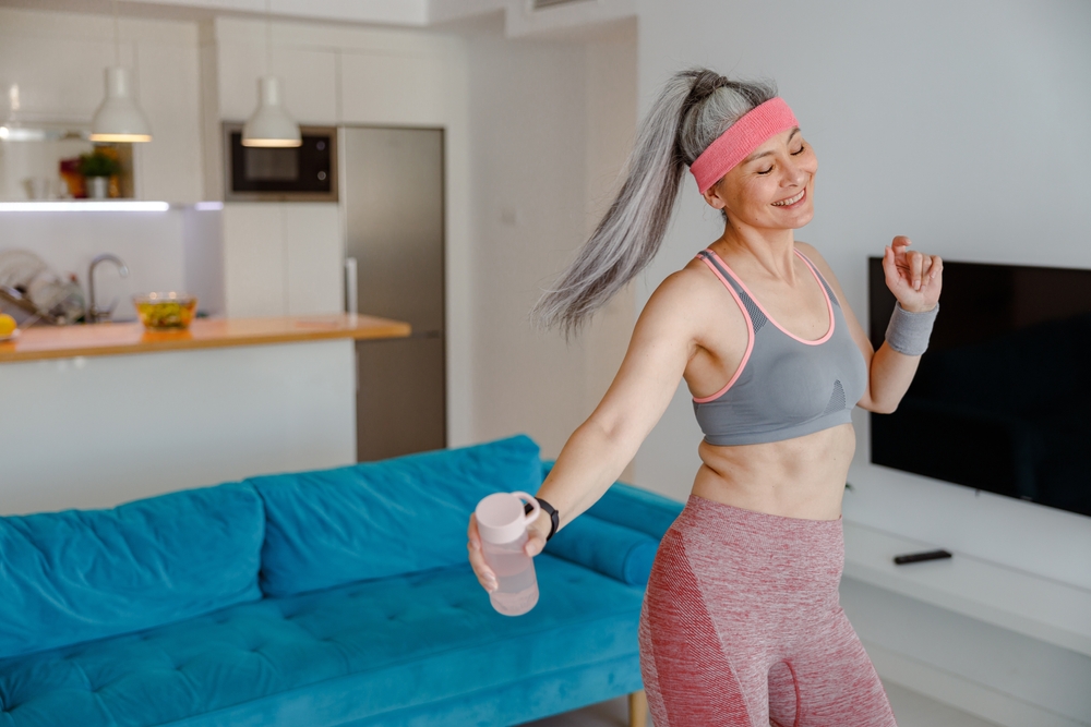 Sporty,Female,Person,In,Sportswear,Holding,Bottle,Of,Water,And