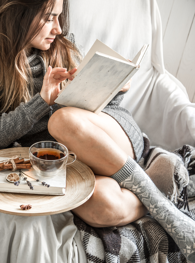 Cute,Girl,On,A,Comfortable,Chair,With,Tea,,reading,A