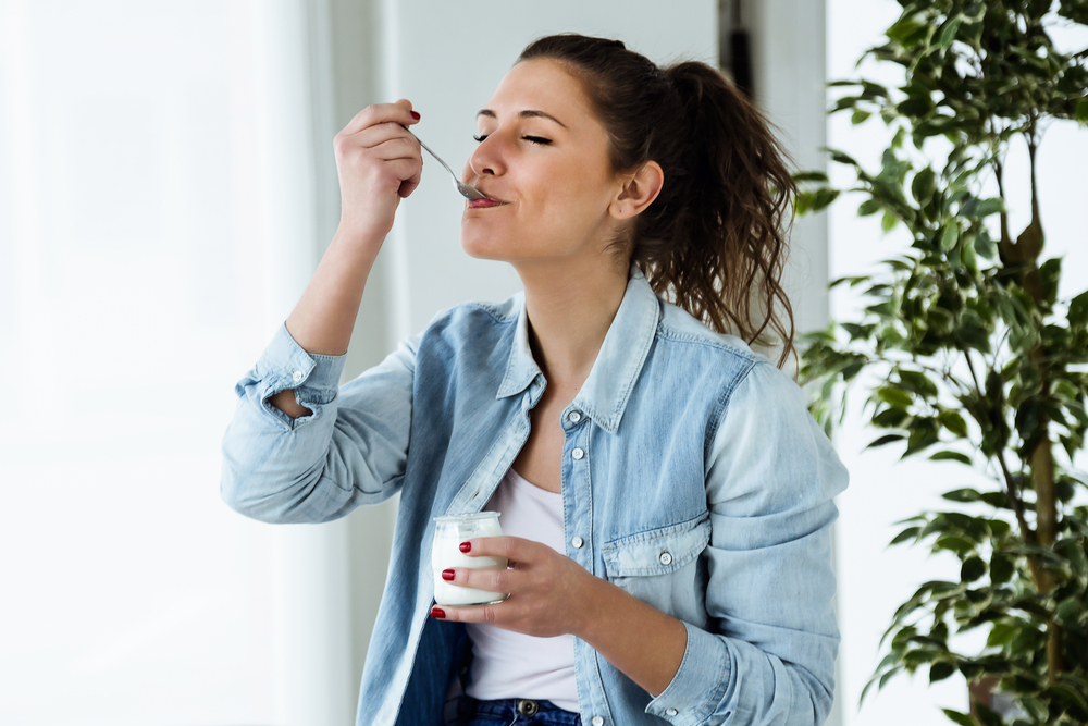 Portrait,Of,Beautiful,Young,Woman,Eating,Yogurt,At,Home.