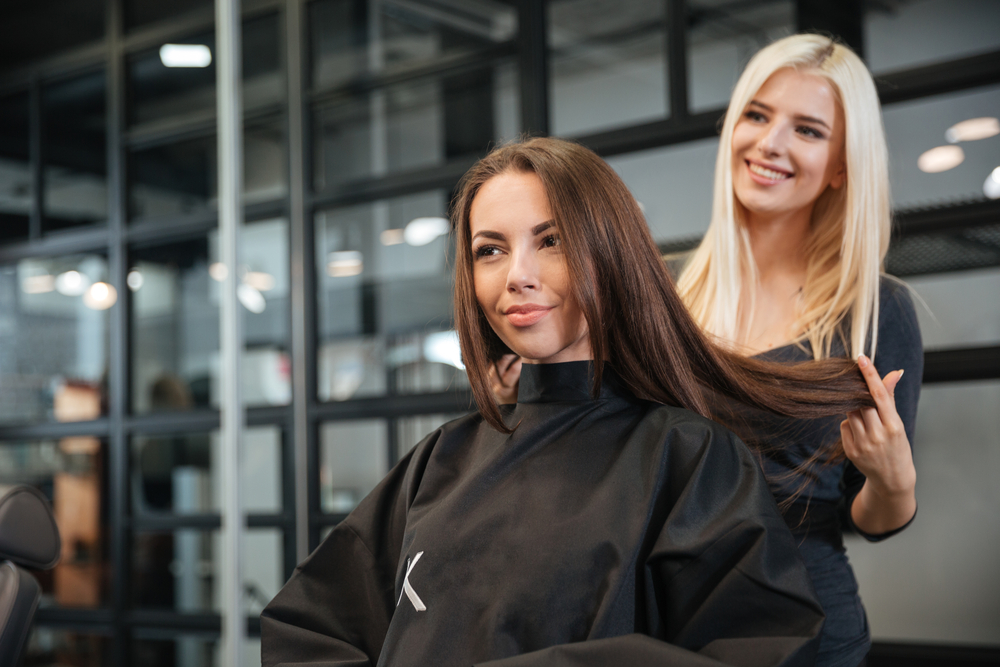 Young,Hairdresser,Giving,A,New,Haircut,To,Female,Customer,At