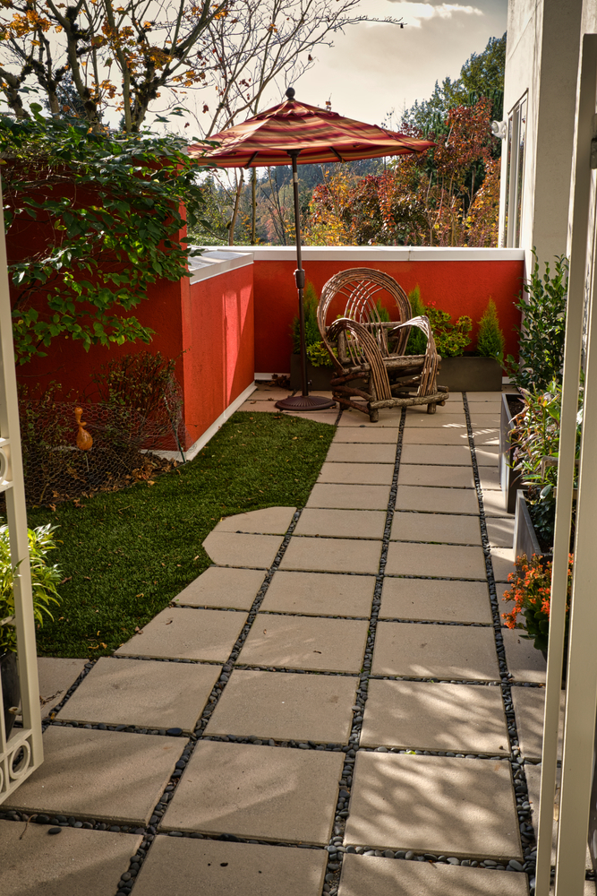 A,Small,Courtyard,With,Various,Plantings,And,A,Bright,Orange